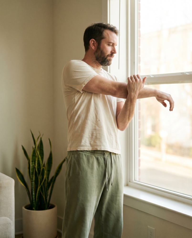 A man stretching in soft morning light
